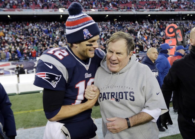 New England Patriots quarterback Tom Brady celebrates with head coach Bill Belichick after defeating the Miami Dolphins in a  game in Foxborough, Mass., in December 2014. Donald Trump trotted out their calls and notes to him on the eve of the election.