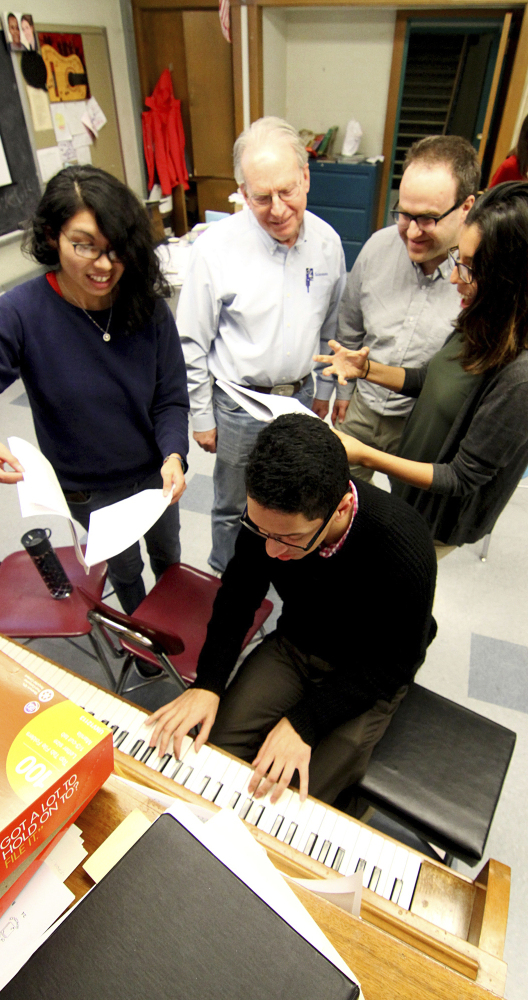 UMass Lowell student Mirza Garcia, from left, professors Jesse Heines and Dan Walzer and students Nicole Vasconcelos and Christian Hernadez at piano.