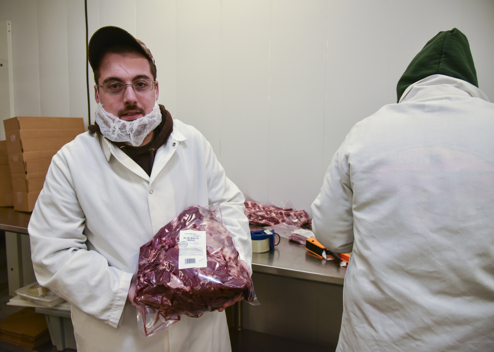 Kevin Boucher, a hazard analysis critical control point coordinator at Central Maine Meats in Gardiner, inspects meat to be sure it's halal-certified. Halal is food that adheres to Islamic law, as defined by the Quran.