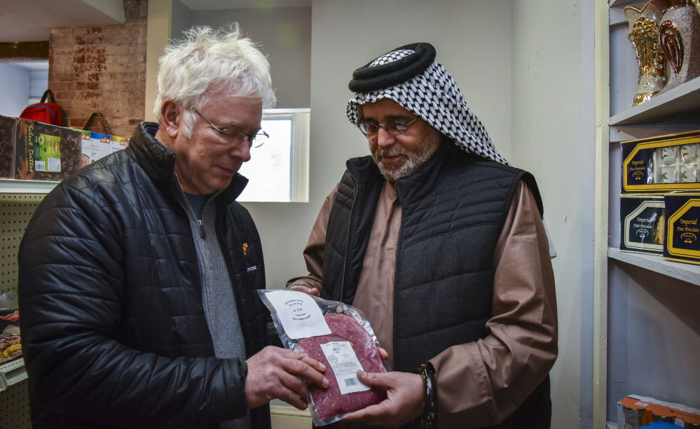 Central Maine Meats co-owner Joel Davis, left, discusses distribution of halal meat with Khalid Zamat, owner of a new Iraqi grocery store in Hallowell. Halal-certified meat is processed at Central Maine Meats in Gardiner.