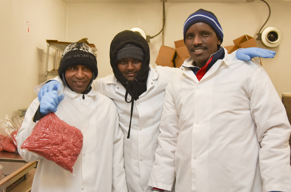 Central Maine Meats employees, from left, Hassan Aweig, Mohamud Aden, and Muhamed Mussa assist in processing meat according to halal standards. The employees are Muslim and immigrated to Gardiner from Somalia.