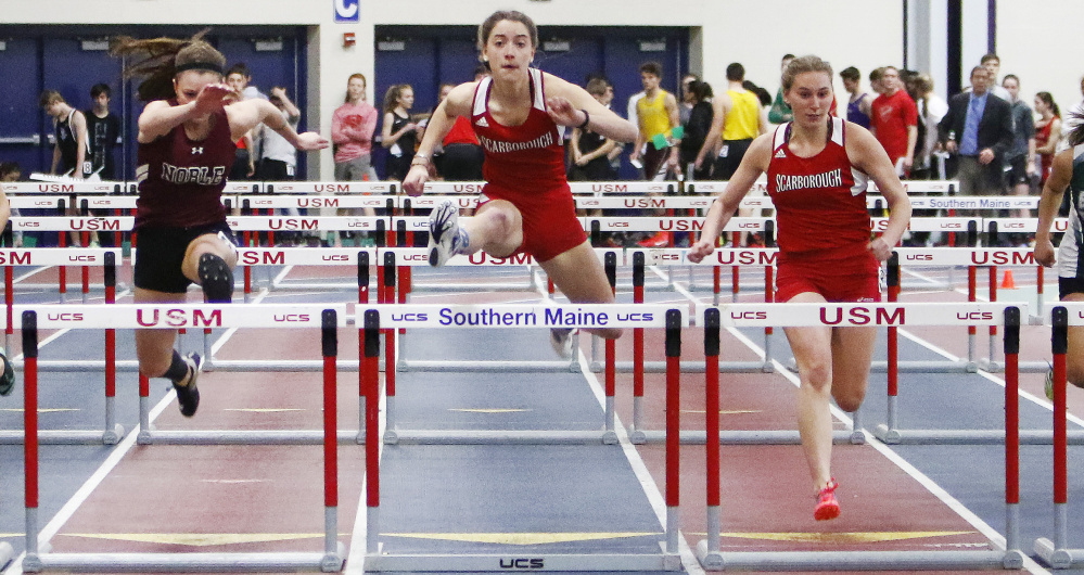 Ellen Shaw, center, of Scarborough clears the final hurdle on her way to victory in the senior 55-meter hurdles, helping the Red Storm win the girls' team championship.