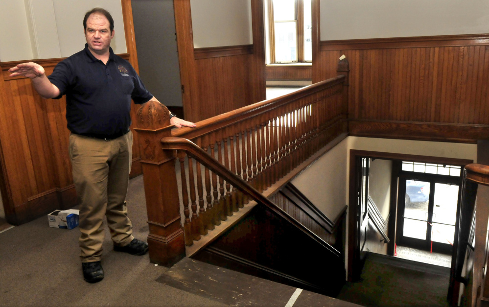 Travis Works, executive director of the Cornville Regional Charter School, points out the ornate woodwork, including the stairwell, in the former courtroom.