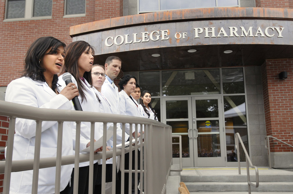 Members of UNE's first pharmacy class attend a dedication ceremony at the Portland campus in 2009. From the Fitch report: "UNE has grown total (full-time equivalent) enrollment by over 30 percent in the past five years, largely by adding or expanding its graduate and professional programs in the health and social sciences fields."