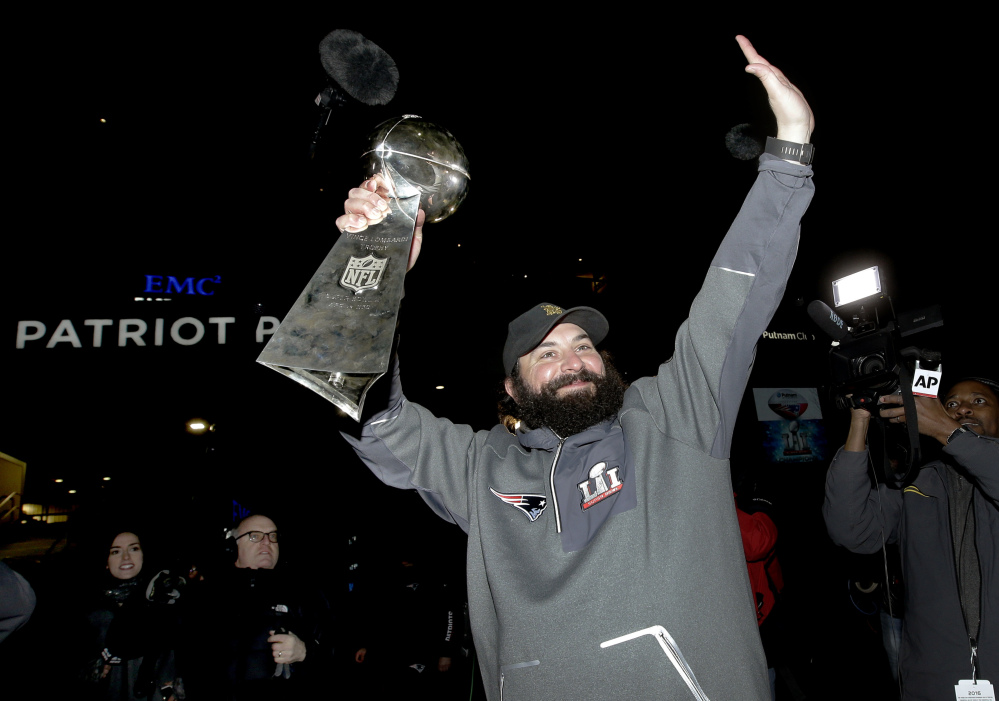 New England Patriots defensive coordinator Matt Patricia raises the Super Bowl trophy following the team's arrival at Gillette Stadium, Monday, Feb. 6, 2017, in Foxborough, Mass., after defeating the Atlanta Falcons 34-28 Sunday in the NFL Super Bowl 51 football game in Houston. (AP Photo/Steven Senne)