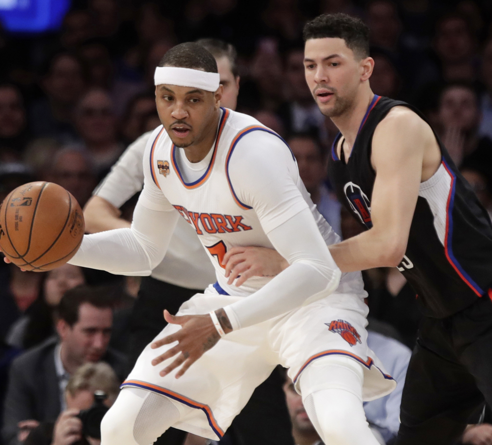 The Clippers' Austin Rivers, right, defends the Knicks' Carmelo Anthony during the first half Wednesday in New York. The 119-115 Los Angeles victory was overshadowed by the arrest of Knicks legend Charles Oakley.