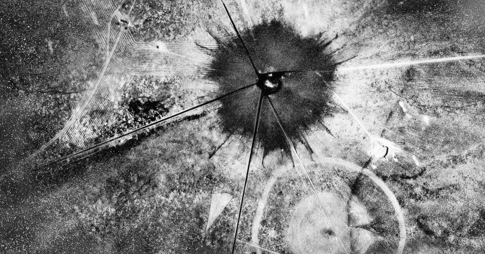 The surface damage in New Mexico from the atomic bomb test in 1945 can be seen in this aerial view. Descendants who suspect the blast damaged the genes of nearby residents are lobbying for compensation and U.S. government apologies.