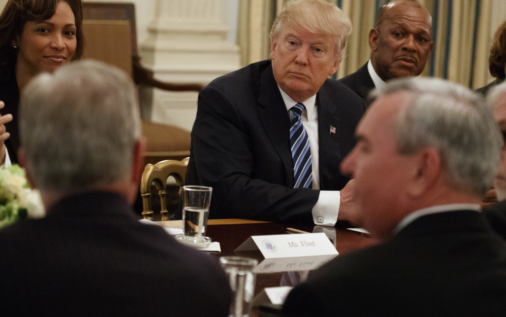 President Trump listens Thursday during a meeting with airline and airport executives at the White House. Trump, who once ran his own airline, pledged to help the companies deliver "the greatest service" with minimum delays and at the lowest cost in modernized facilities.