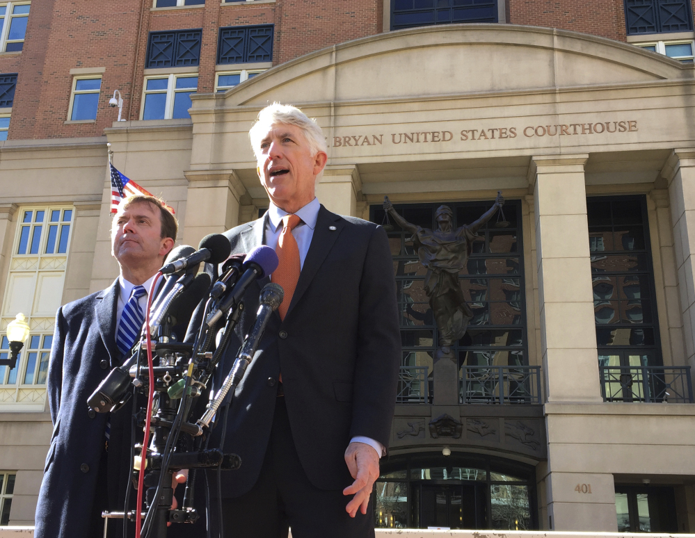 Virginia Attorney General Mark Herring, right, accompanied by Virginia Solicitor General Stuart Raphael, speaks outside the federal courthouse in Alexandria, Va., on Friday after a hearing on President Trump's travel ban.