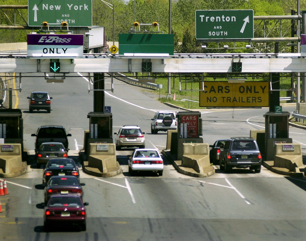 Cars pass through toll lanes as they enter the New Jersey Turnpike at Exit 9 in East Brunswick, N.J. Most drivers grudgingly pay tolls on bridges and highways but some go to great lengths to avoid them.