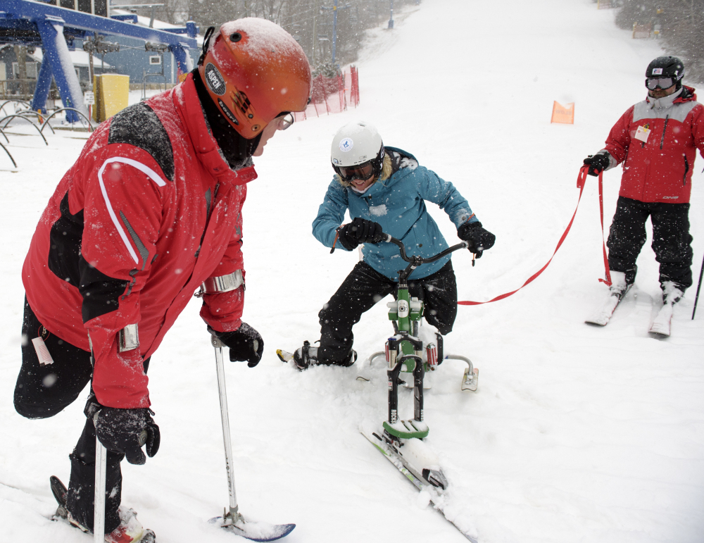 Connecticut state Senator Ted Kennedy, Jr., left,  goes down the slopes with Julie Carman and Bert Van de Weerdt, right. Kennedy, who lost a leg to bone cancer as a 12-year-old, visited with LOF Adaptive Skiers who were offering lessons.