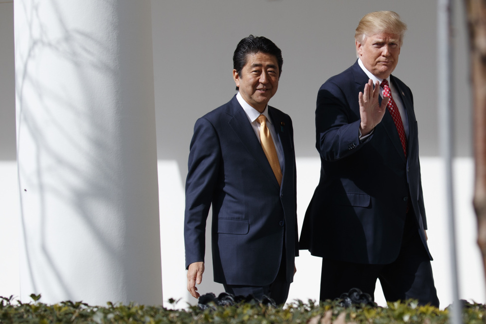 President Trump walks with Japanese Prime Minister Shinzo Abe to a news conference at the White House in Washington on Friday.