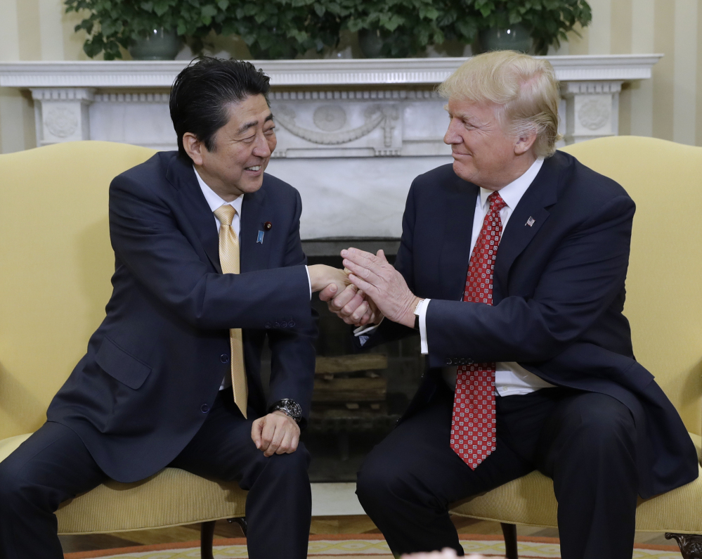 President Trump meets with Japanese Prime Minister Shinzo Abe in the Oval Office of the White House in Washington on Friday. Trump and Abe are scheduled to play golf Saturday.