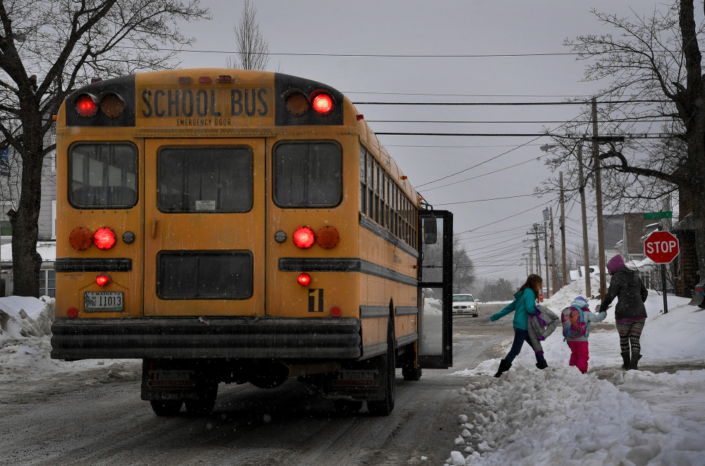 A school bus lets children off early as a snowstorm approaches in East Millinocket. 