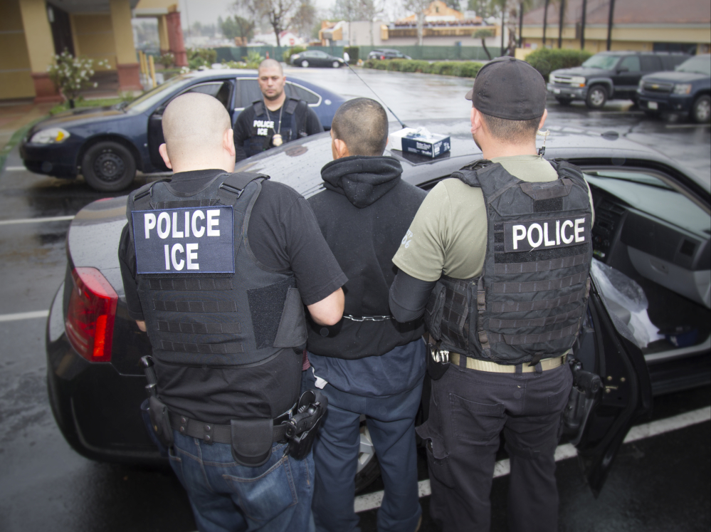 Foreign nationals are shown being arrested Tuesday during a targeted enforcement operation conducted by U.S. Immigration and Customs Enforcement in Los Angeles.