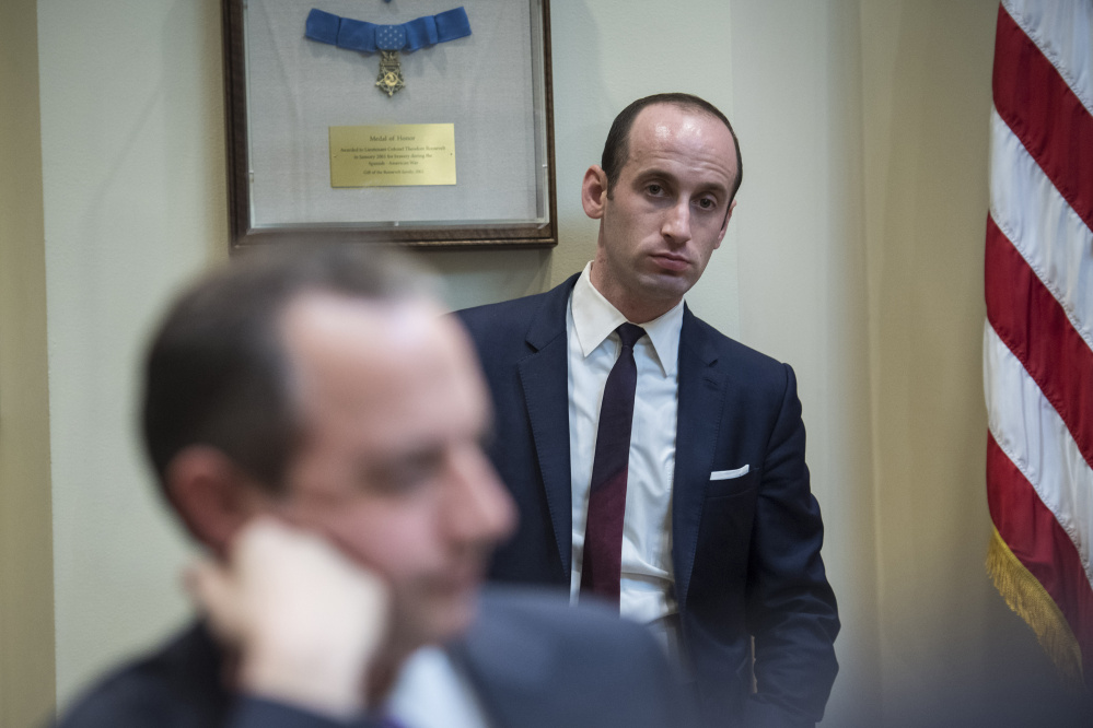 Senior adviser Stephen Miller talks with White House Chief of Staff Reince Priebus, foreground. Miller has come under close scrutiny after he crafted a 90-day immigration ban.