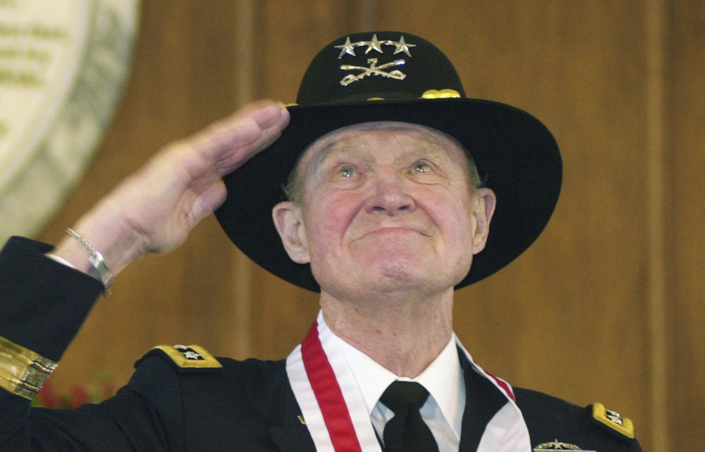 Retired Lt. Gen. Hal Moore salutes the crowd during a standing ovation at the Spirit of Alabama Awards in Montgomery, Ala., in 2004.