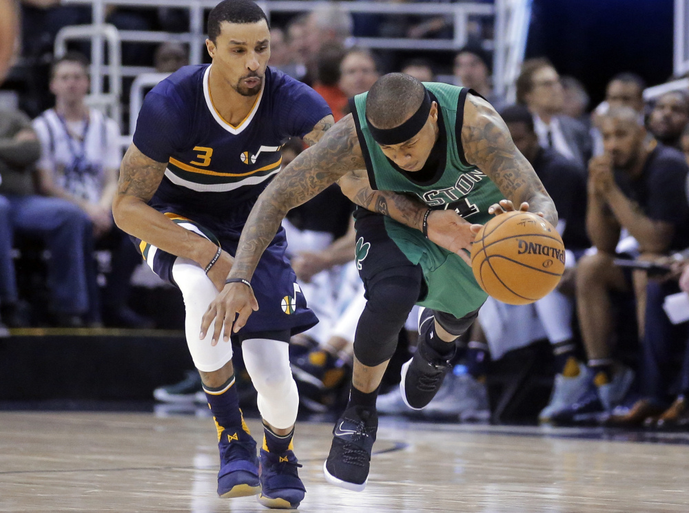 Utah Jazz guard George Hill defends as Boston guard Isaiah Thomas, right, drives up the court during the second half Saturday in Salt Lake City. The Celtics won 112-104.