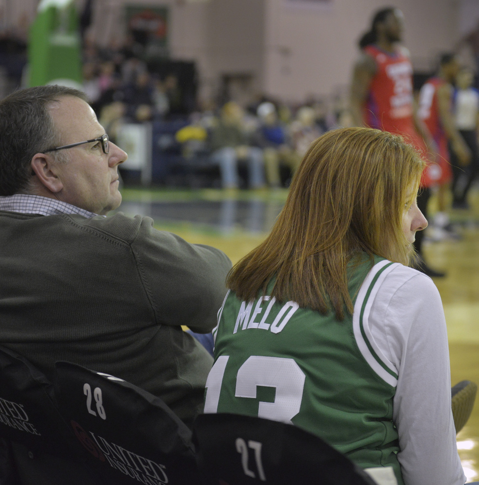 Stacey Ryan sports a Flo Melo Boston Celtics jersey while attending the Red Claws game with her husband, Bill Ryan Jr. The team owner, Ryan Jr. remembers Fab Melo, who died Saturday, "always had a smile on his face."