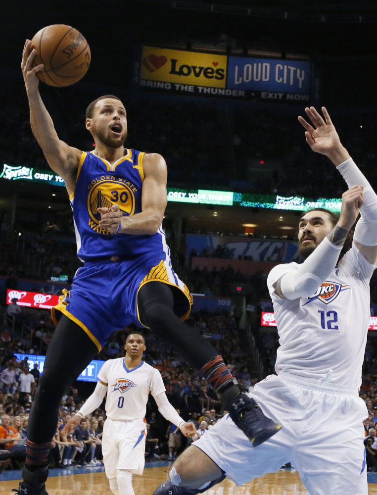 Golden State's Stephen Curry soars past Oklahoma City's Steven Adams during a 130-114 win on Feb. 11. Curry's scoring average is down with Kevin Durant on the team, but "we are about winning," he said.