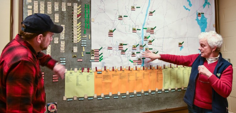 Jerry Dostie, left, Augusta street superintendent, reviews the city's snow operations map with Public Works Director Lesley Jones during Monday's storm. The map tracks 21 plow routes in Augusta and the drivers assigned to each.
