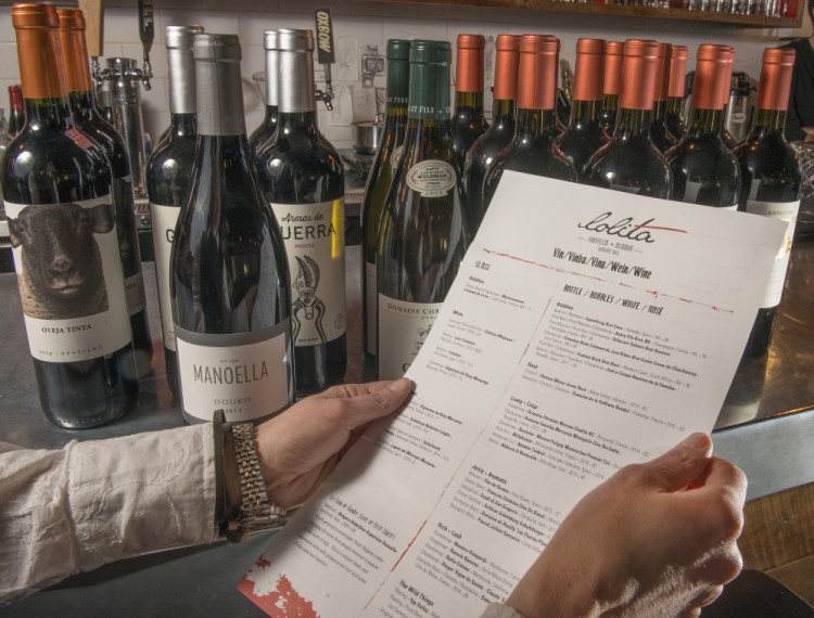 Stella Hernandez, co-owner of Lolita restaurant in Portland, with Lolita's wine list, which she wrote herself.