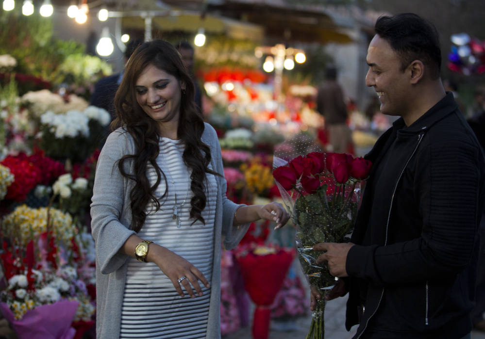 A couple buy flowers Monday in Islamabad, Pakistan. A judge banned Valentine's Day celebrations in the country's capital, saying they are against Islamic teachings.