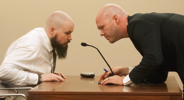 Leroy Smith III, left, confers with defense attorney Scott Hess in January during a hearing on Smith's mental competence to be tried for murder, in connection with the slaying and dismembering of his father in May 2014.