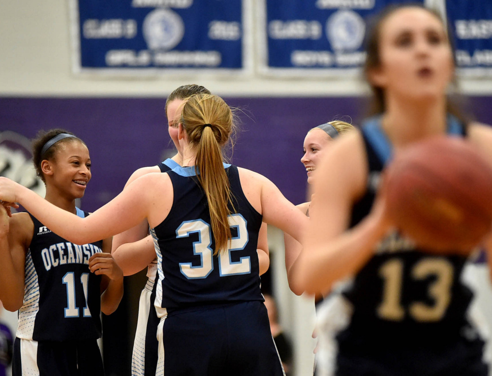 Oceanside players celebrate their impending victory over Waterville as Gabby Simmons sinks both free throws in the final seconds of Tuesday night's Class A North girls' basketball prelim at Waterville.
