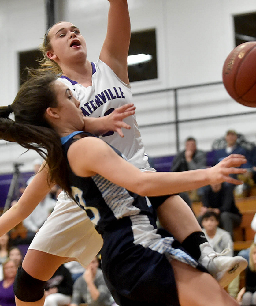 Waterville's Mackenzie St. Pierre gets fouled by Oceanside's Gabby Simmons in Tuesday's Class A North prelim. Oceanside won 48-39 after losing twice to the Purple Panthers in the regular season.