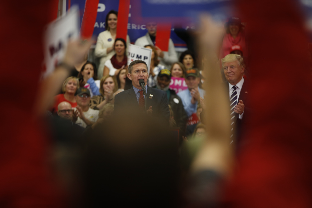 Michael Flynn appears with candidate Donald Trump at a campaign stop at the Open Door Christian Academy in Lisbon, Maine, on Oct. 28.