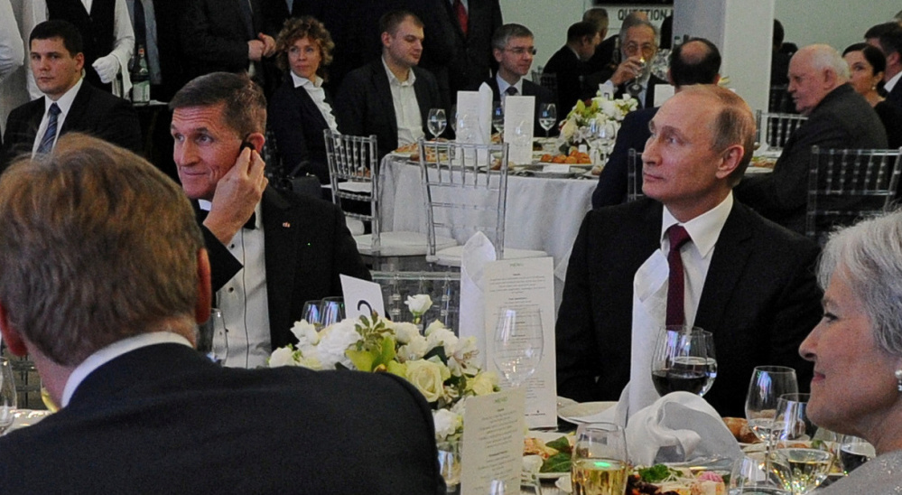 Russian President Vladimir Putin, right, sits next to Flynn at an event in Moscow in 2015. Flynn misled administration officials in denying he had discussed U.S. sanctions with a Russian envoy.