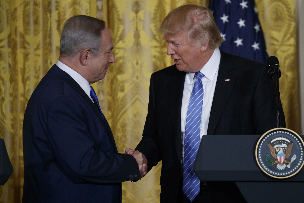 President Trump shakes hands with Israeli Prime Minister Benjamin Netanyahu during their joint news conference in the East Room of the White House on Wednesday in Washington.