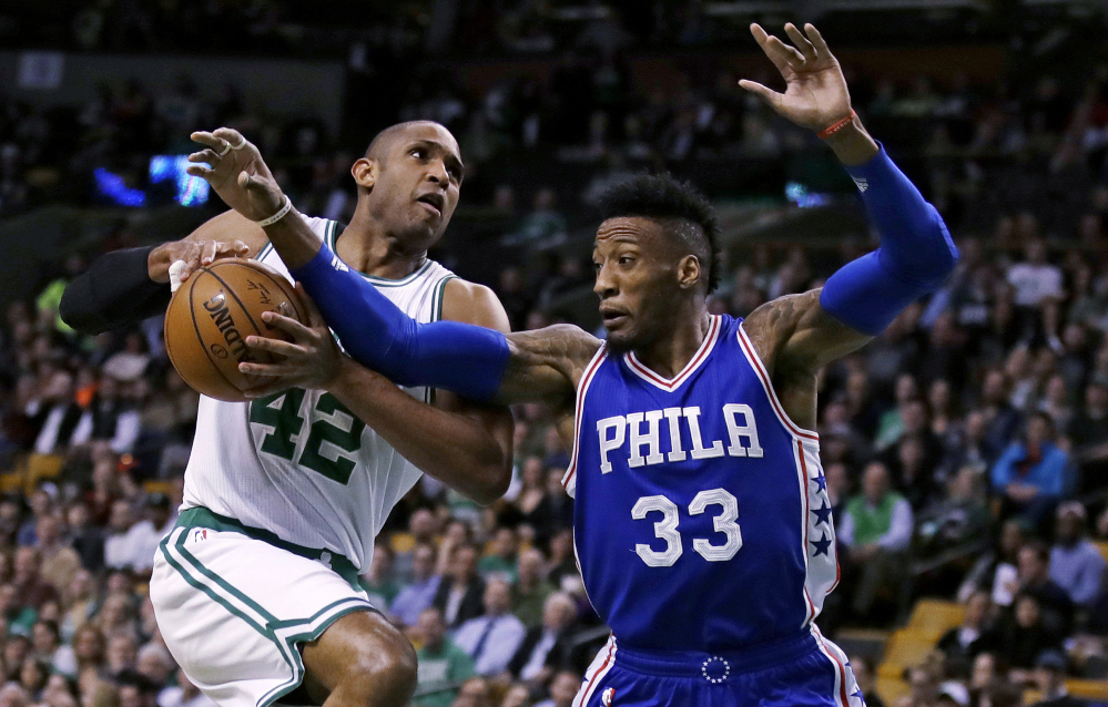 Celtics center Al Horford is blocked by Philadelphia's Robert Covington on a drive to the basket in the first quarter Wednesday night in Boston.