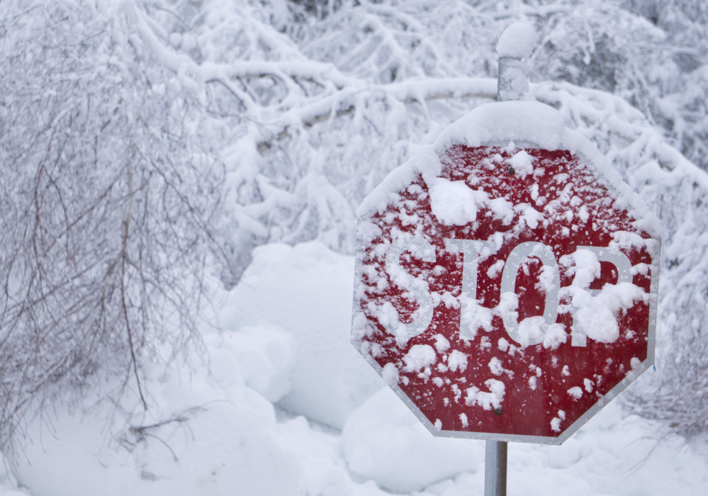 KENNEBUNK, ME - FEBRUARY 16: A stop sign in Kennebunk is coated in wet snow on Thursday morning, February 16, 2016. Stop is what many Mainers may be thinking this morning as they wake up to another day of digging themselves out from more snow that fell overnight. (Staff Photo by Gregory Rec/Staff Photographer)