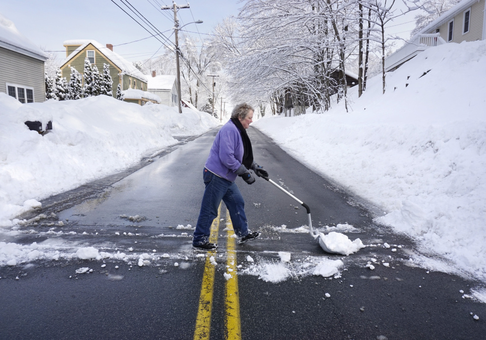 SOUTH BERWICK, ME - FEBRUARY 16: Claire Curtis pushes snow across Old Fields Road in South Berwick on Thursday, February 16, 2017. Some residents along Old Fields Road lost power but Curtis says she never lost her power. (/Staff Photographer) KENNEBUNK, ME - FEBRUARY 16: A stop sign in Kennebunk is coated in wet snow on Thursday morning, February 16, 2016. Stop is what many Mainers may be thinking this morning as they wake up to another day of digging themselves out from more snow that fell overnight. (Staff Photo by Gregory Rec/Staff Photographer)