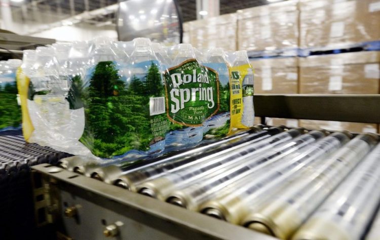 Packaged bottles of Poland Spring water move down a conveyer belt at the company's plant in Hollis. Poland Spring is one of the top private employers in Maine, with more than 900 workers in the state at its peak in 2016.