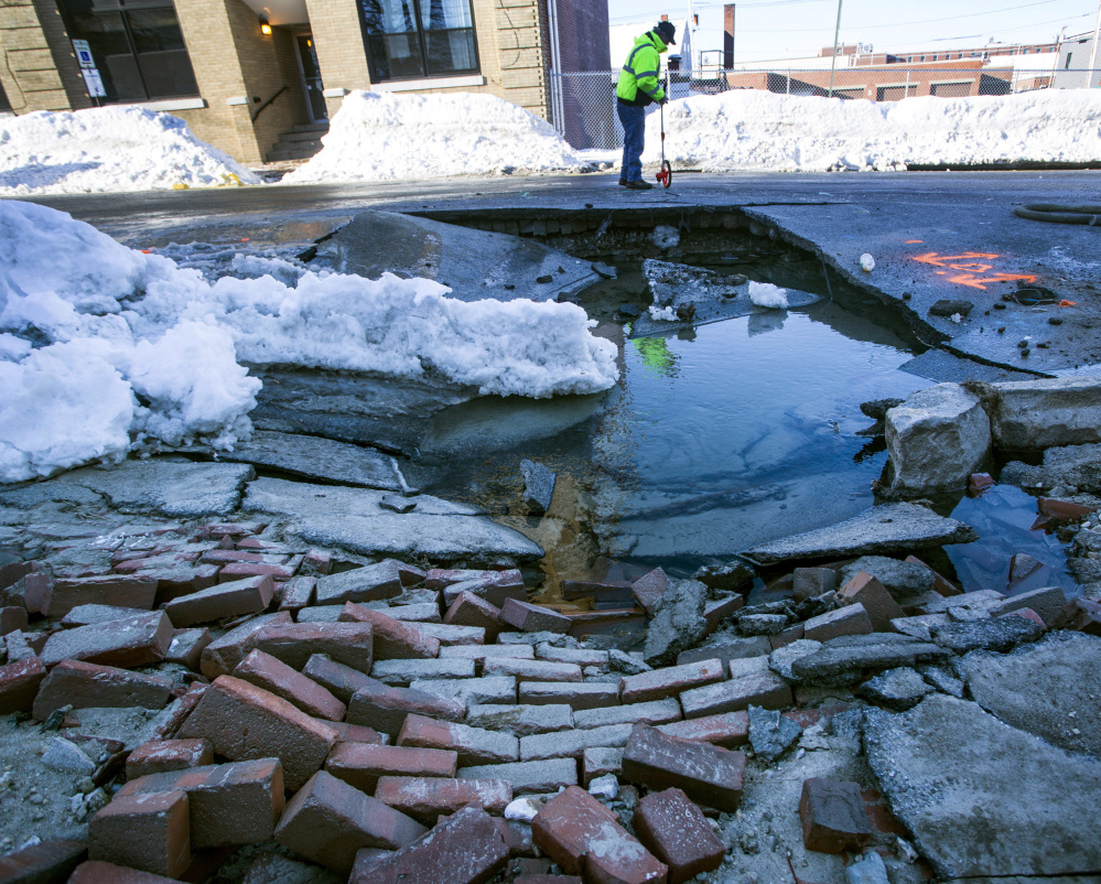 Workers on Friday said it would be hours before they got to the pipe at the center of a water main break on Preble Street in Portland. The break flooded streets and triggered a boil-water order for Munjoy Hill residents.