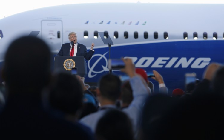 President Trump speaks to Boeing employees on Friday in the final assembly building at Boeing South Carolina in North Charleston. The president visited the plant where Boeing rolled out the first 787-10 Dreamliner aircraft from its assembly line, visible behind him.