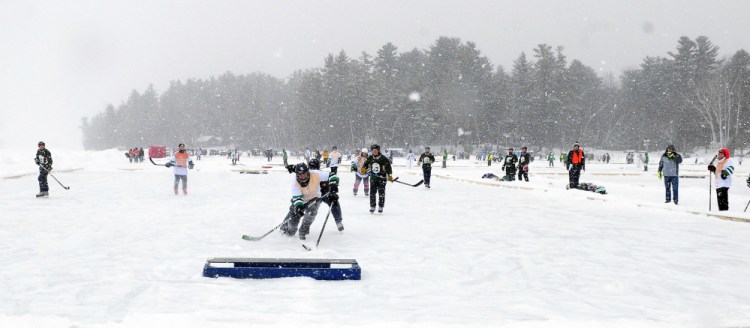 One game on one end of the pond, another game on the other end. It's the Maine Pond Hockey Classic in Sidney, and more than 400 players playing with pucks were having a ball.