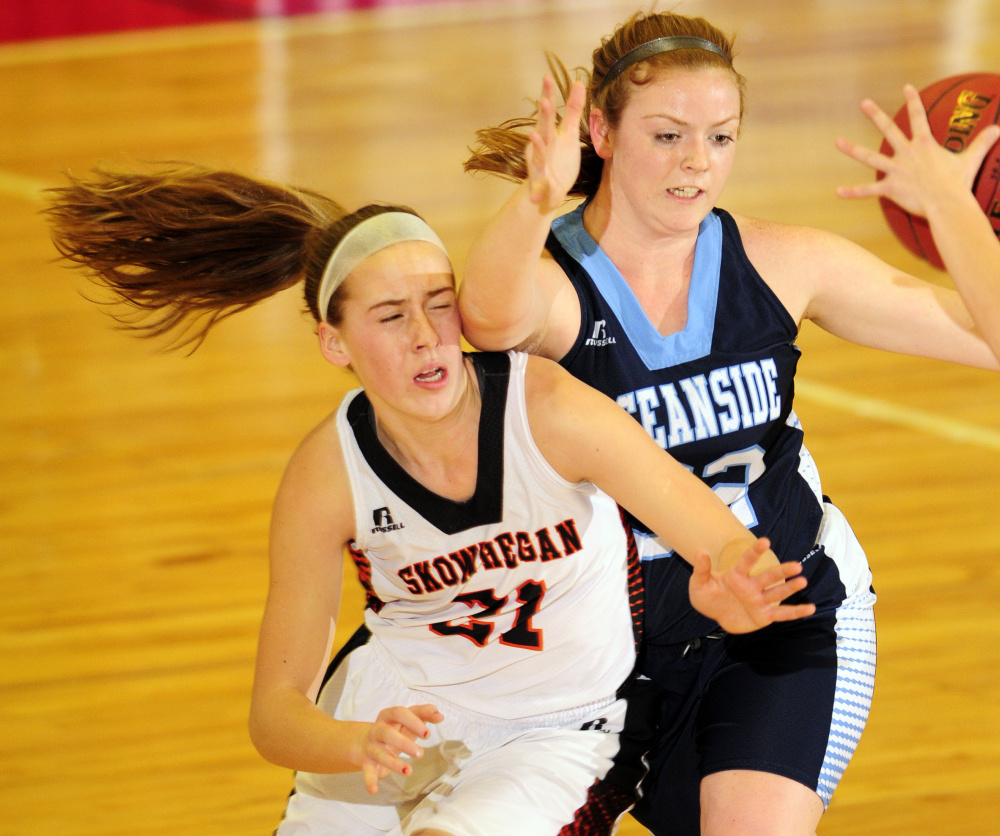 Skowhegan's Annie Cooke, left, battles for a rebound with Alexis Mazurek of Oceanside during a Class A North basketball quarterfinal Friday at the Augusta Civic Center. Skowhegan advanced with a 50-41 victory.