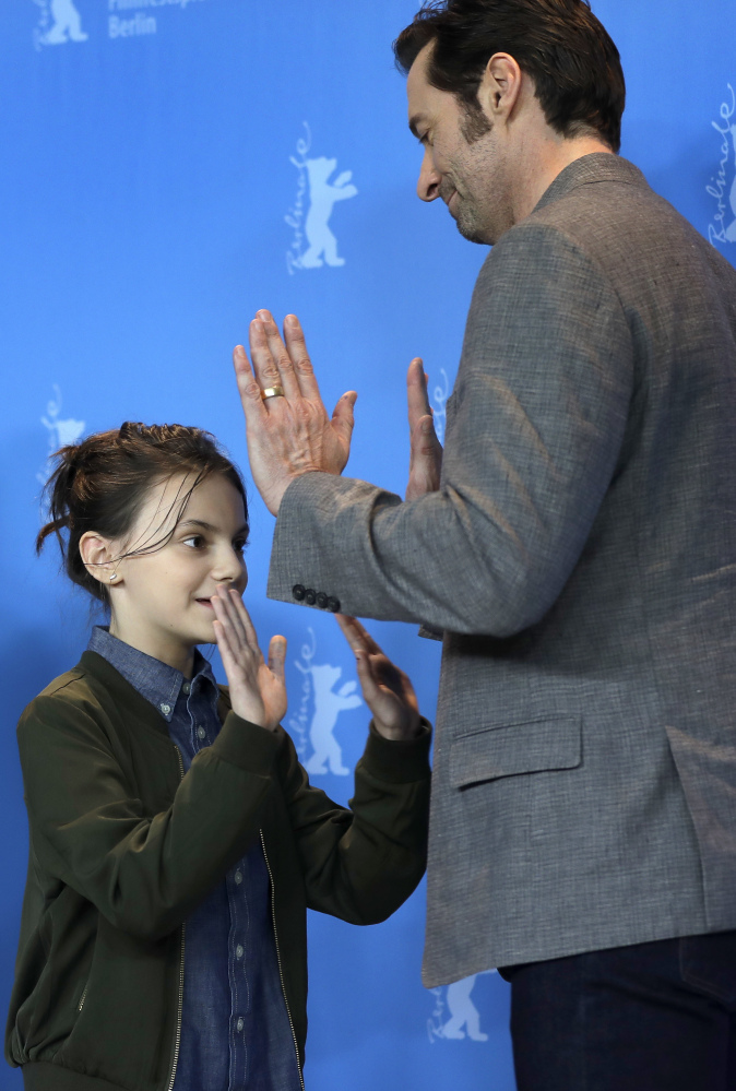 Actor Hugh Jackman and actress Dafne Keen joke during a photo op for the film "Logan" at the 2017 Berlin Film Festival in Berlin, Germany, on Friday.