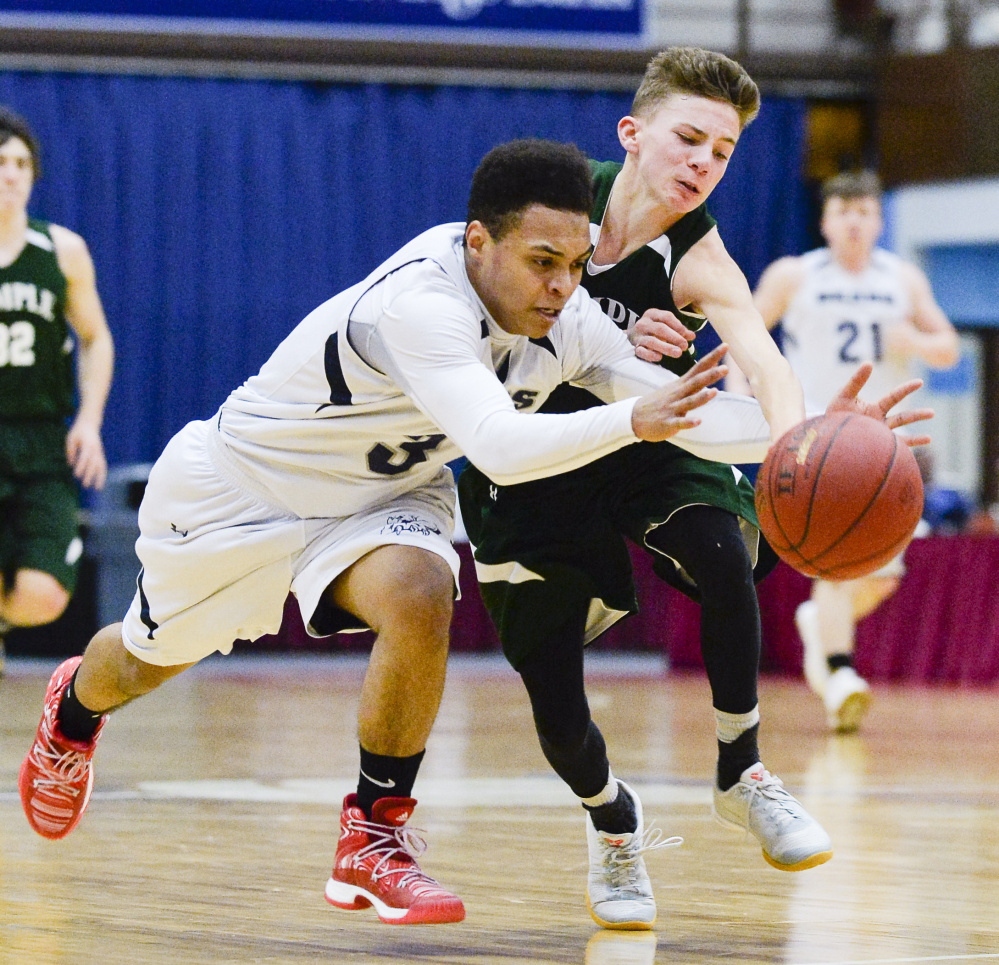 Tyrese Collins, left, of A.R. Gould races to a loose ball in front of Micah Riportella of Temple during a Class D South boys' basketball quarterfinal Saturday at the Augusta Civic Center. A.R. Gould won 76-63 and will play Vinalhaven in the semifinals.