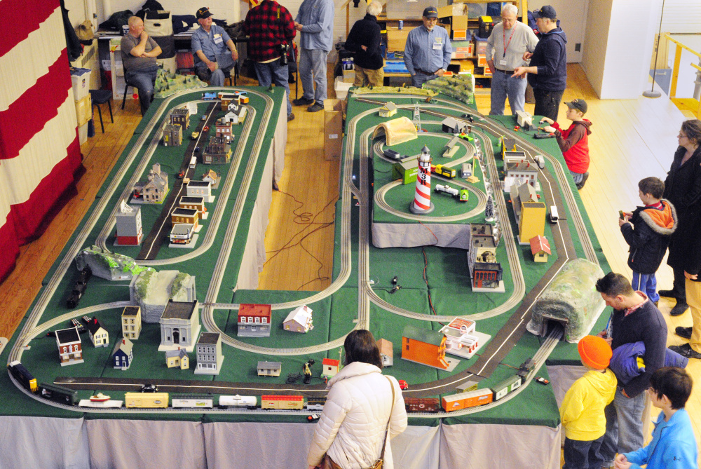 People examine the Maine 3 Railers Club's model railroad layout Saturday during the 31st annual Whitefield Lions Club Model Railroad and Doll House Show at the Augusta State Armory.