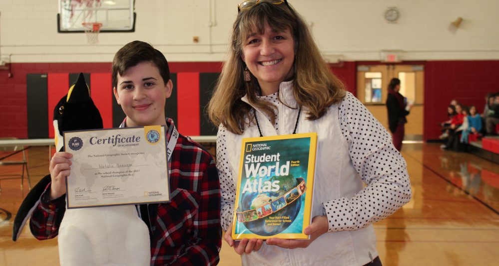 Wells Junior High eighth-grader Natalie Hanagan celebrates her National Geographic Bee win with teacher Bonnie Dill. Hanagan has been invited to the state contest in March in Farmington, for a chance to advance to the 29th Annual National Geographic Bee sponsored by the National Geographic Society in Washington, D.C.