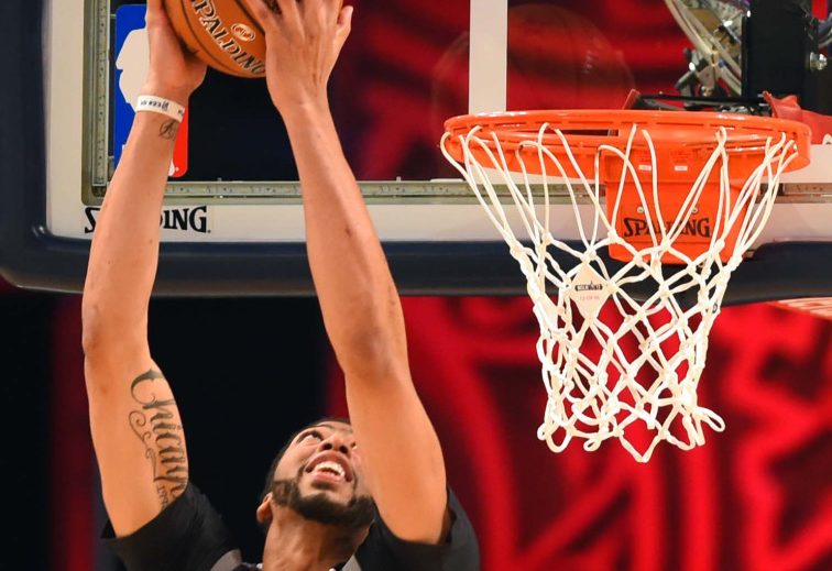Anthony Davis throws down a reverse dunk on his way to a record-setting performance in the NBA All-Star game on Sunday in New Orleans. Davis scored 52 points, breaking the record of 42 set by Wilt Chamberlain 55 years ago.
