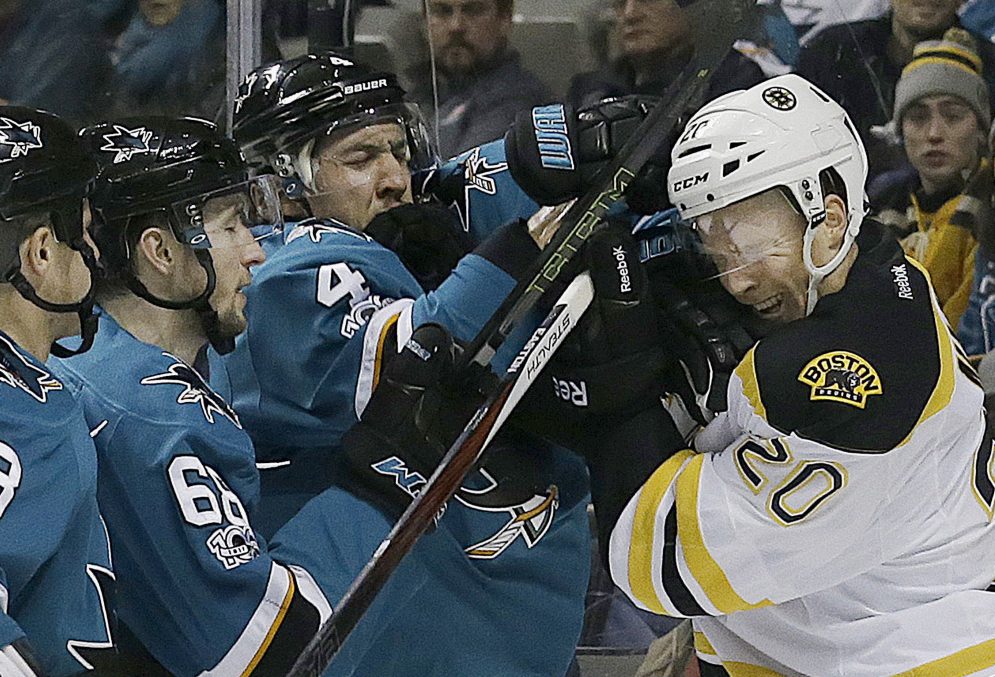 Associated Press/Jeff Chiu
Boston's Riley Nash, right, and San Jose's Brenden Dillon, 4, shove each other during the second period Sunday in San Jose, Calif. Boston won in overtime, 2-1.