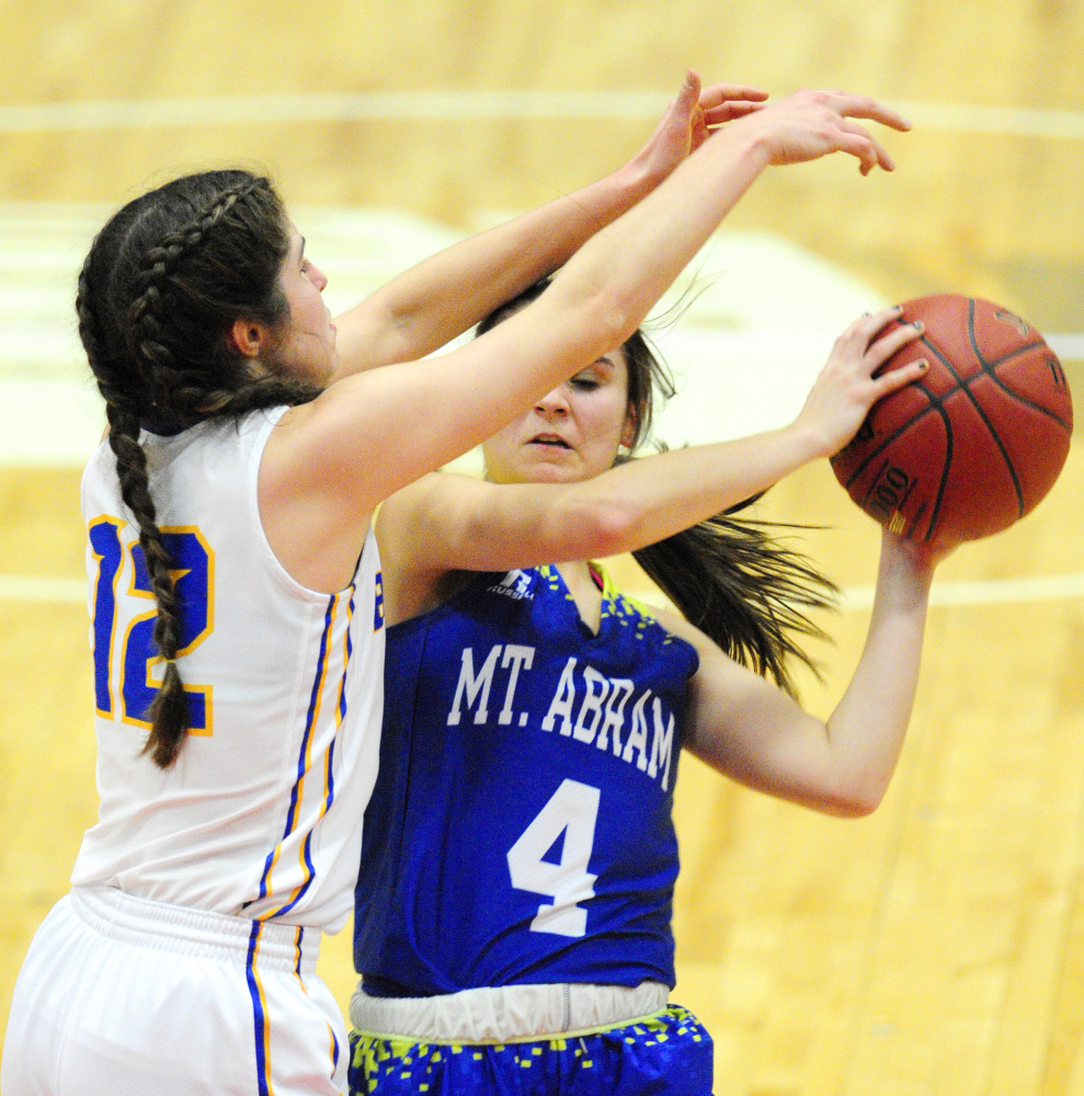 Boothbay's Kate Friant, left, defends Mt. Abram guard Lindsay Huff during a Class C South quarterfinal Monday at Augusta Civic Center. Boothbay advanced with a 60-21 victory.