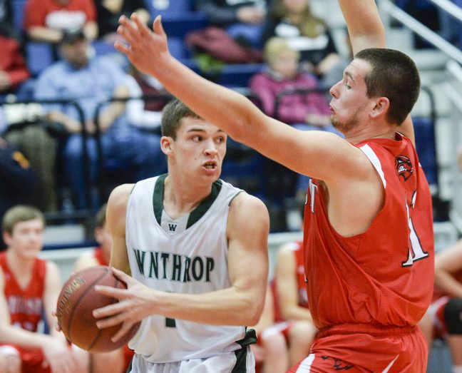 Winthrop's Bennett Brooks, left, looks to make a pass while being defended by Wiscasset's Nathanial Woodman early in their Class C South quarterfinal Monday in Augusta. Winthrop won 76-42.
