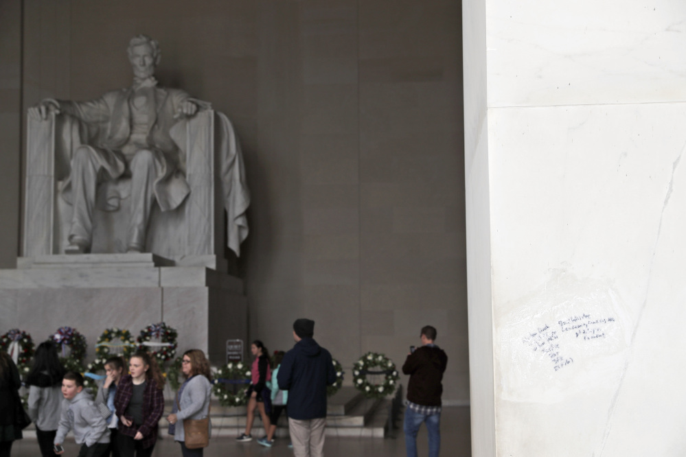 Graffiti mars the wall at right at the Lincoln Memorial on Tuesday in Washington.